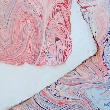 Handmade Marbled Paper- Red with Light and Dark Blues showing front and back sides with edge deckle