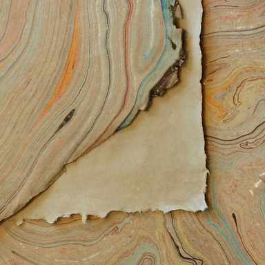 Handmade Marbled Paper- Tan with Gold, Red, Blue showing front and back sides with edge deckle