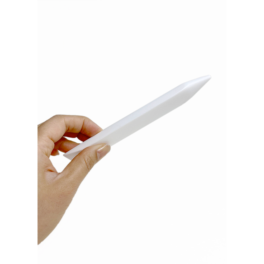 White Teflon Folder held in a hand