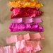Stack of colorful ruffled crepe paper layers on a beige background