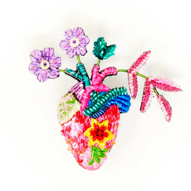 Colorful heart-shaped anatomical heart beaded brooch with floral elements on a white background