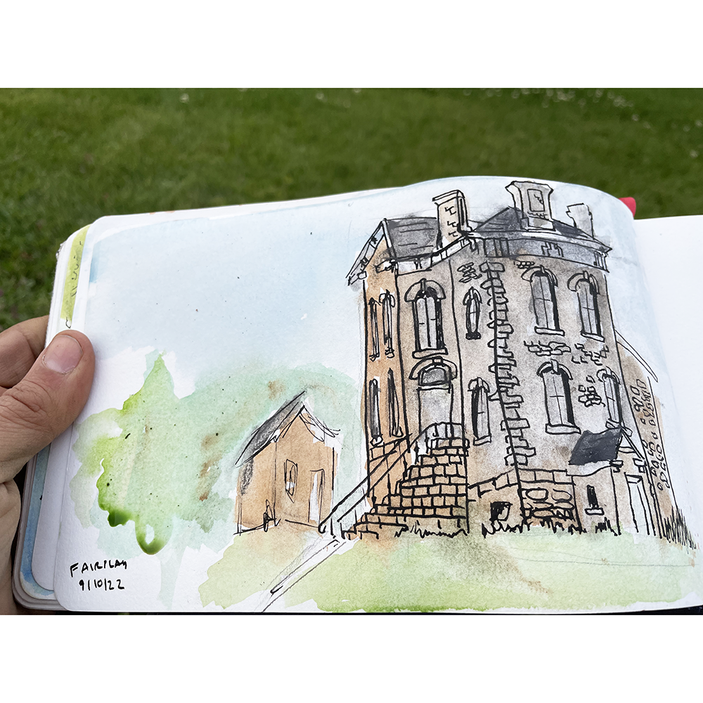Travel & Sketch - Urban Sketching On Location Class with sketch of building shown in notebook