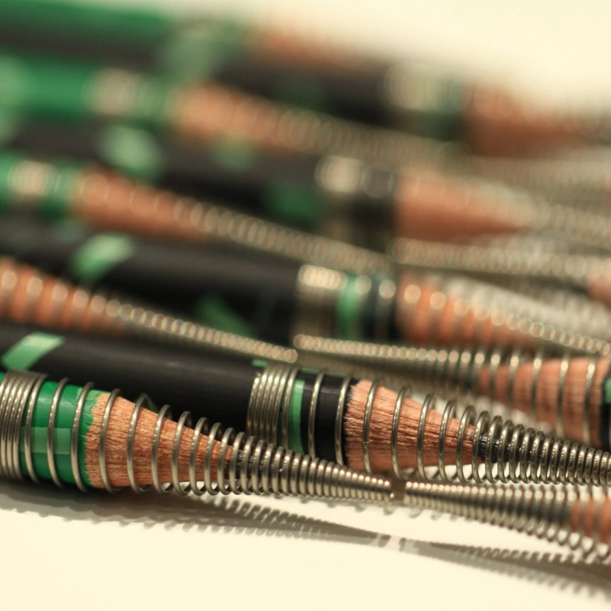 Wound-Wire Pencil Cap- image shows a close-up pf pencil caps on sharpened pencils