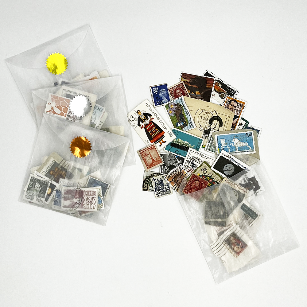 Vintage Stamp Pack showing a variety of stamps and glassine envelope packaging