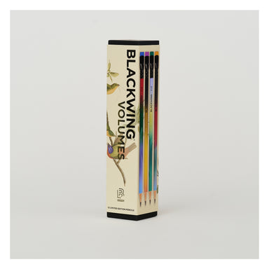 A boxed set of pencils standing upright in a tall rectangular package. The package is cream-colored with black text reading 'BLACKING VOLUMES' and illustrations of birds and branches.