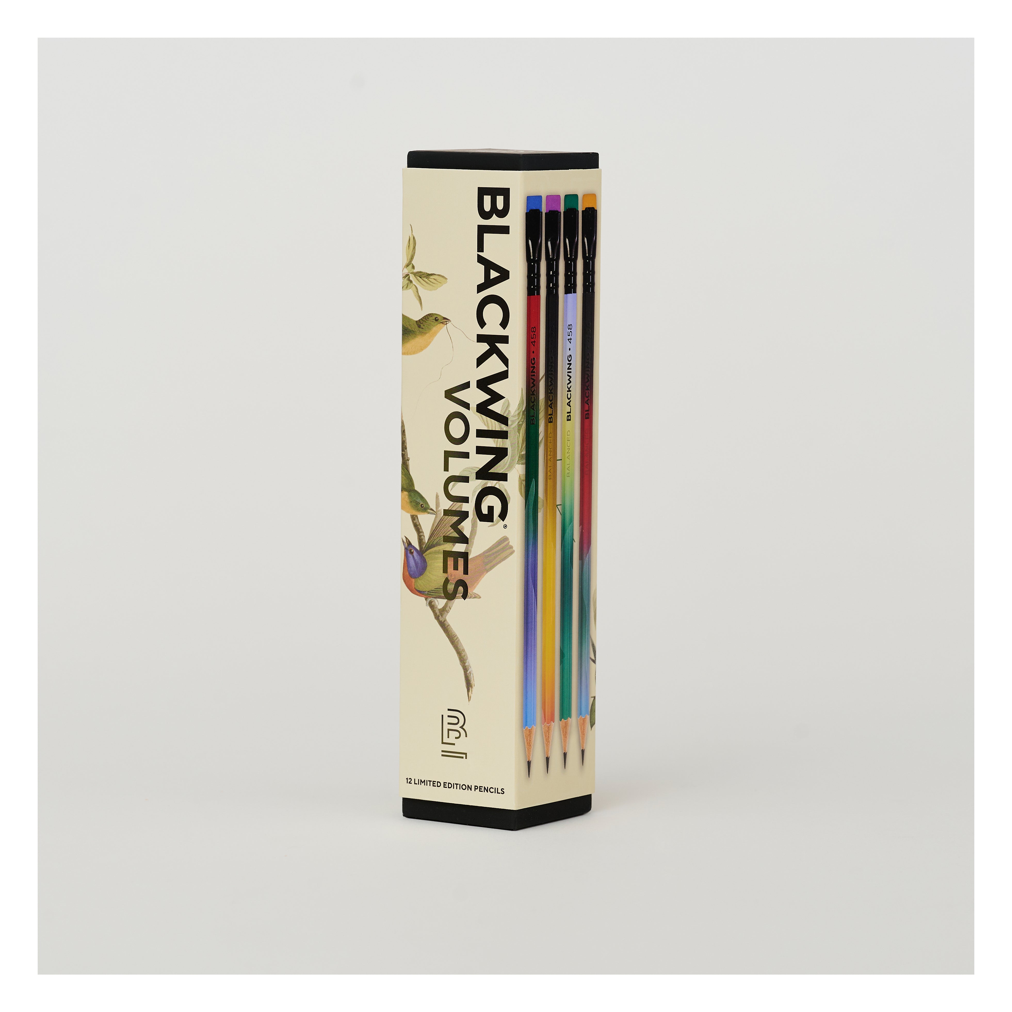 A boxed set of pencils standing upright in a tall rectangular package. The package is cream-colored with black text reading 'BLACKING VOLUMES' and illustrations of birds and branches.