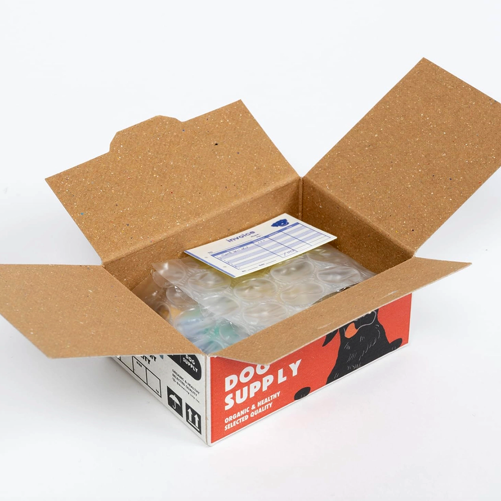Open cardboard box with a label and contents on a white background