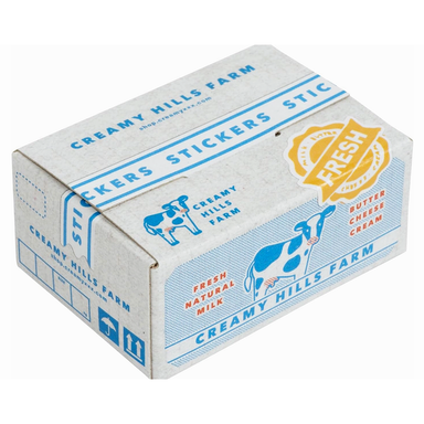 Box of Creamy Hills Farm stickers with cow illustrations and branding.