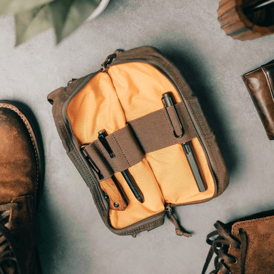 Lochby Venture Pouch in brown, with yellow interior shown open