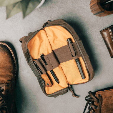 Lochby Venture Pouch in brown, with yellow interior shown open