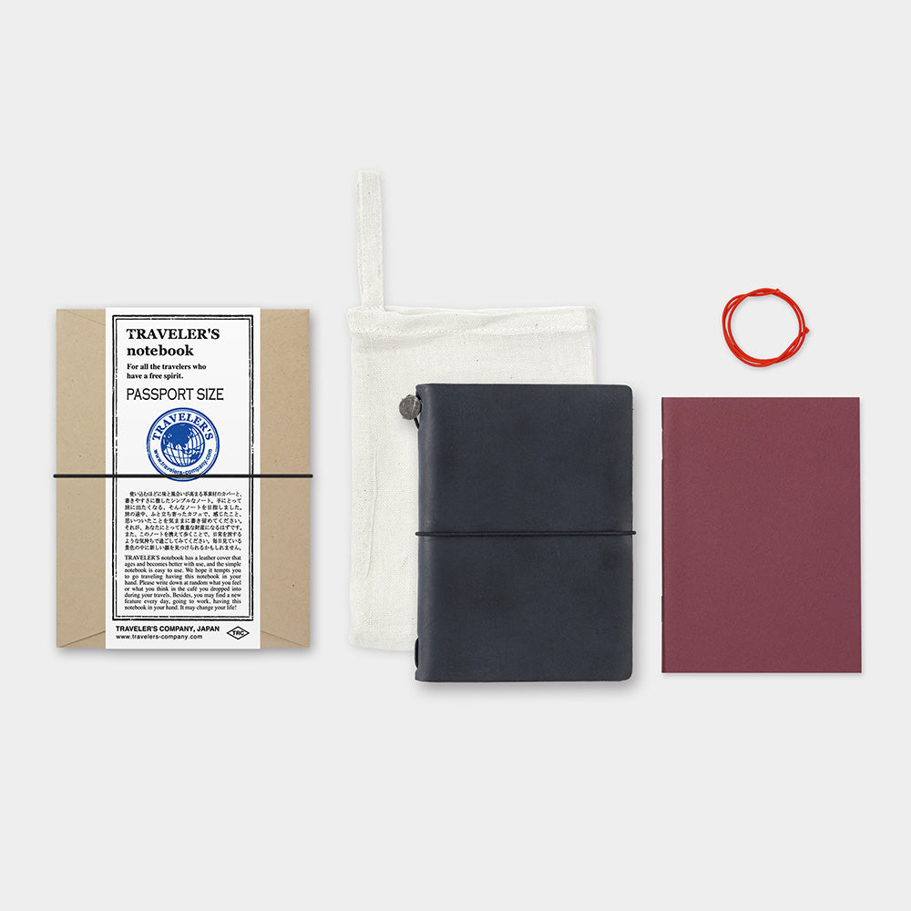 The passport starter kit features a black leather cover, a blank notebook refill, a spare rubber band, and a cotton case.
