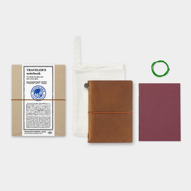 The starter kit features a passport sized camel leather cover, a blank notebook refill, a spare rubber band, and a cotton case.