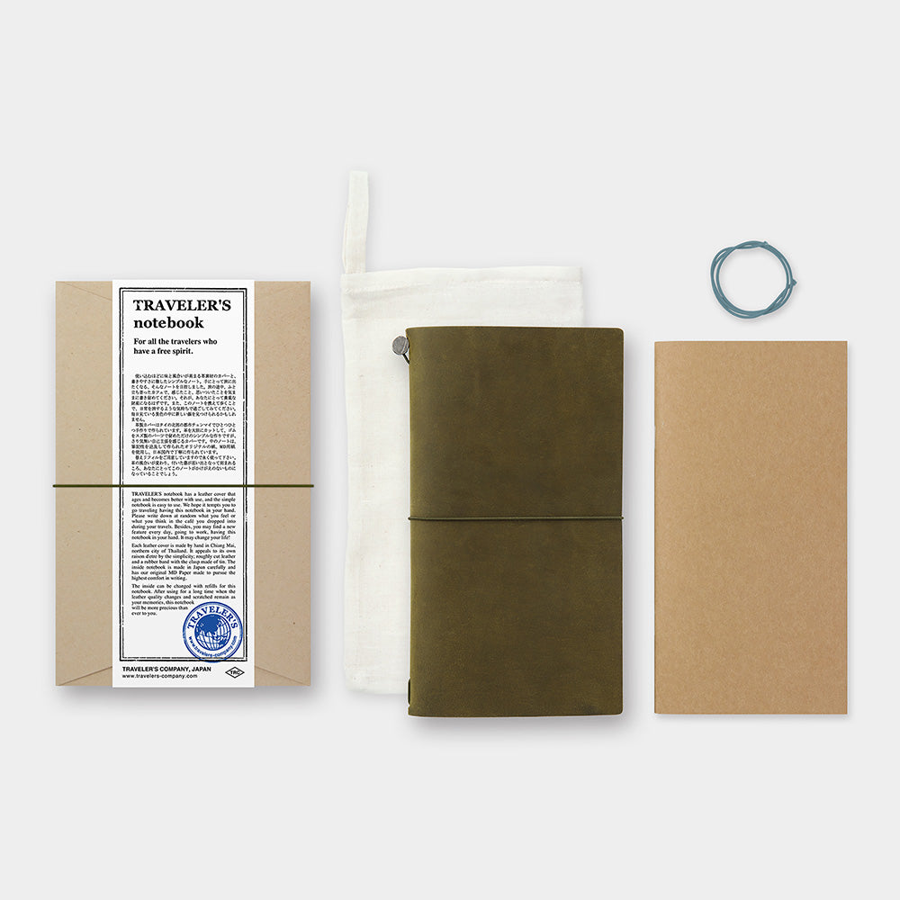 The TRAVELER'S notebook Olive Starter Kit comes with an Olive leather cover, a blank MD paper notebook refill, a spare rubber band, and a cotton case.