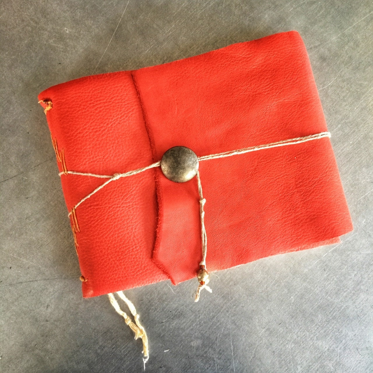 The Little Red Leather Journal Class sample front cover- red book with string tie and metal button