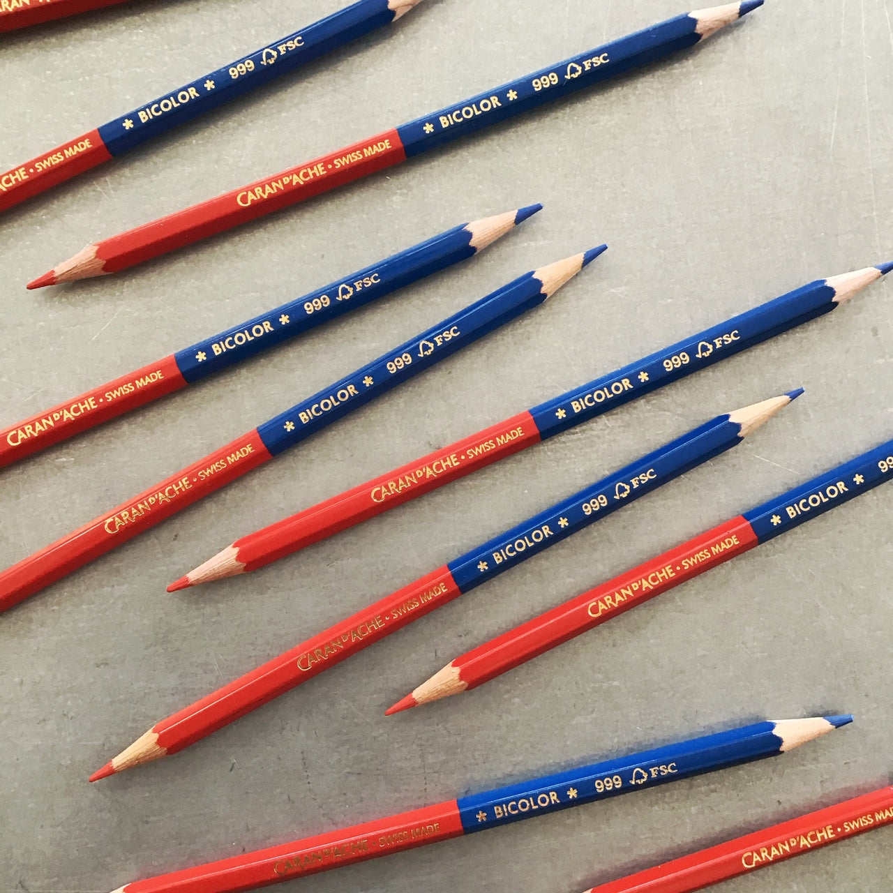 Caran d'Ache Bicolor Pencil- Red and Blue single pencils on a table