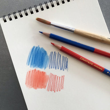 Caran d'Ache Bicolor Pencil- Red and Blue drwan on white paper pad shown with watercolor brush and tested on paper
