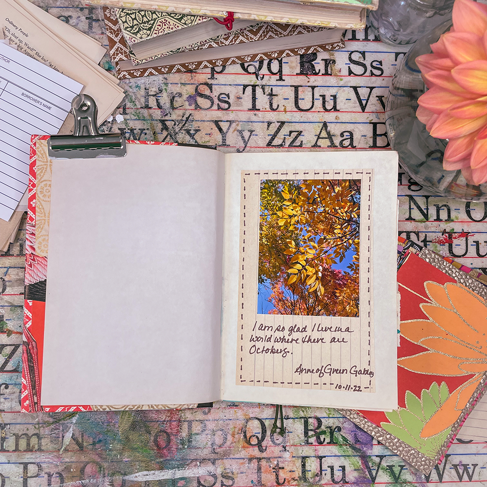 Altered Book - Art of the Word class sample of interior pages- fall leaves with handwritten quote "I am so glad I live in a world where there is October- Ann of Green Gables"