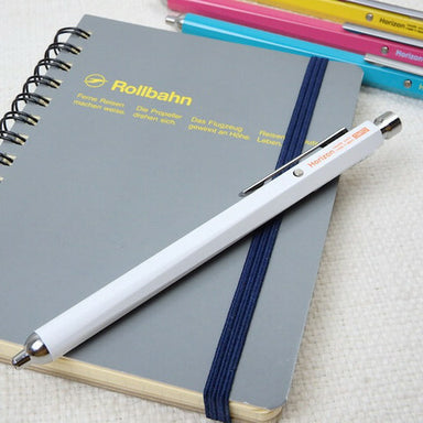 Ohto Horizon EU Needlepoint Ballpoint White Pen on grey notebook