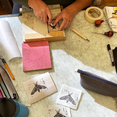 Block Printing – Celebrating Pollinators carving a woodblock with class samples