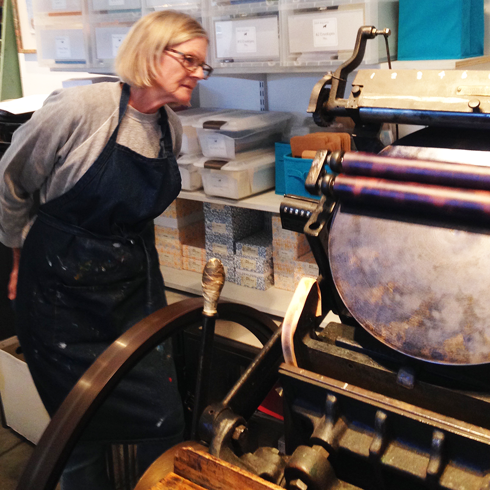 Using Metal Type – Intro to Letterpress class- student reviewing the press.