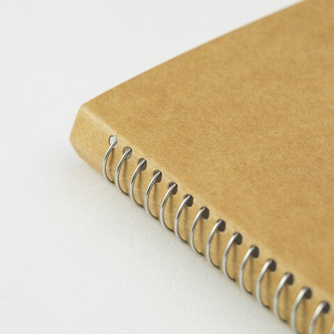 Traveler's Company spiral bound notebook has chrome colored coil. 